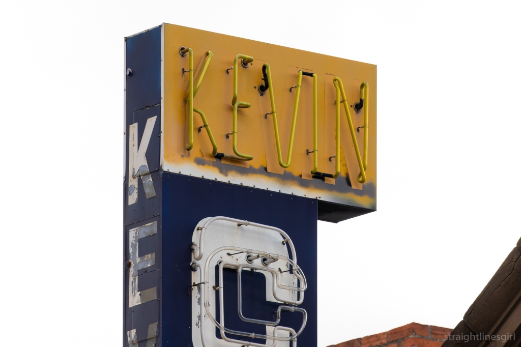 A neon sign of the word KEVIN In yellow text