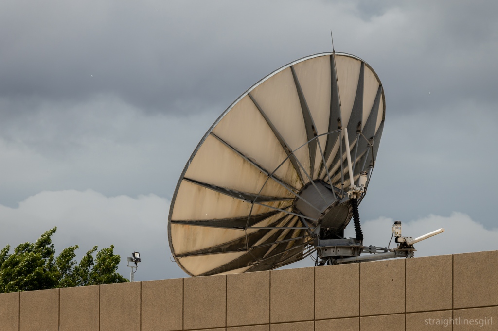 A satellite dish atop a wall