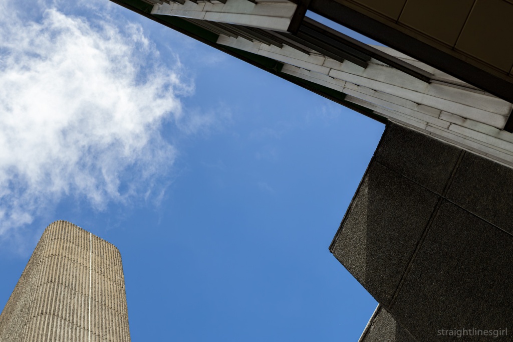 A view looking up at some modernist buildings