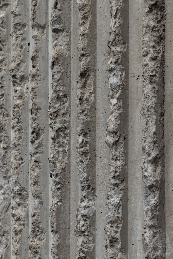 Close up of ragged concrete lines on the side of a building