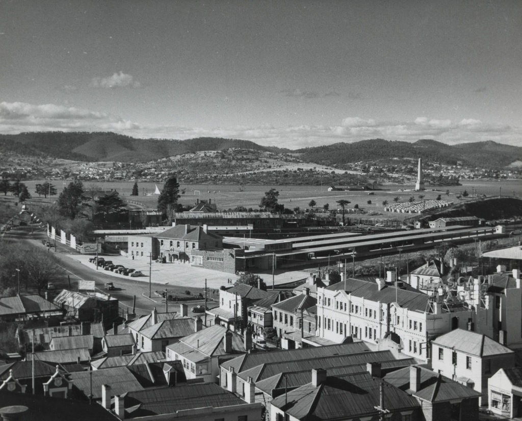 Photograph - Hobart - Railway Terminal, Cenotaph - shows end of Liverpool Street buildings and area where Railway Roundabout and fountain were later built - also street decoration for the 1954 Royal visit (street arch with crown on top)