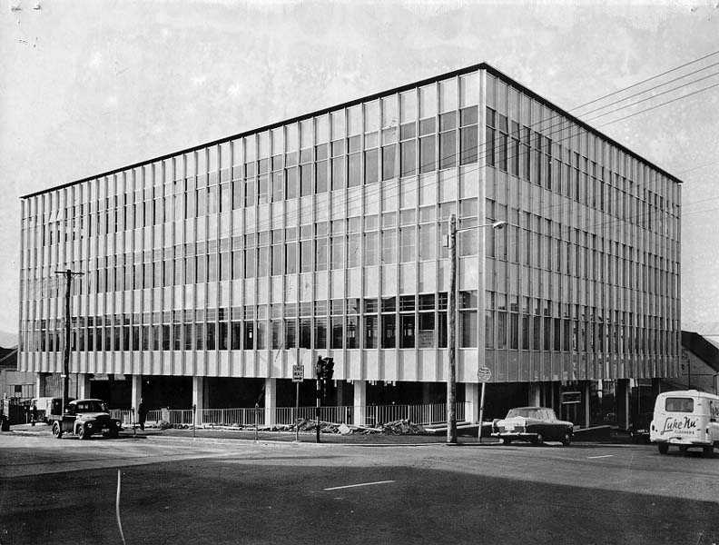 An ols black & white street view of the state library of Tasmania building, a four-story glass curtain facaed